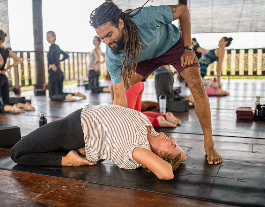 Affordable Yoga Retreat Thailand Chiang Mai Guest Doing Backbend with Instructor Assisting